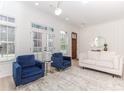 Bright living room with light wood floors, neutral walls, and stylish blue velvet accent chairs at 338 Sugarview Rd, Sugar Hill, GA 30518