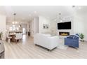 Open-concept living room with fireplace flowing into kitchen, creating a spacious and inviting area at 338 Sugarview Rd, Sugar Hill, GA 30518
