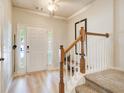 Bright foyer with hardwood floors, staircase with carpeted steps, and natural light streaming in at 3622 Utoy Dr, South Fulton, GA 30331