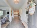 Bright and airy foyer with hardwood floors, a view into the living room and kitchen, and stylish decor at 4931 Pauls Pointe, Sugar Hill, GA 30518