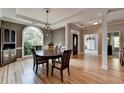 Elegant dining room showcases hardwood floors, arched window, and decorative columns at 1901 Paper Birch Cv, Grayson, GA 30017