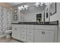 Bathroom featuring double sink vanity with gray countertop and white cabinets at 5149 Roswell Rd # 7, Atlanta, GA 30342