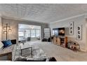 Open living room with modern furnishings, plush carpet, and large entertainment center at 5149 Roswell Rd # 7, Atlanta, GA 30342