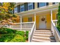 Welcoming front porch with white railings and stairs, perfect for relaxing at 5425 Windswept Trce, Sugar Hill, GA 30518