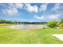 Expansive, well-maintained backyard offering serene water views and a lush green lawn at 11827 Spring Lake Way, Fayetteville, GA 30215