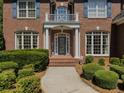 Close up of the front door with brick walkway and carefully trimmed shrubbery at 1320 Kildare Ct, Snellville, GA 30078
