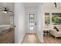 Bright entryway features a decorative glass door, opening to a bedroom and a living area with hardwood floors at 2537 Baker Nw Rd, Atlanta, GA 30318