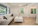 Bright living room with large windows, hardwood floors, modern decor, and track lighting for a sleek look at 2537 Baker Nw Rd, Atlanta, GA 30318