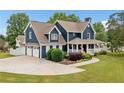 Well maintained two-story home with two car garage, manicured lawn and tasteful landscaping at 2545 Hickory Level Rd, Villa Rica, GA 30180