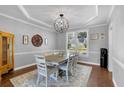 Elegant dining room with decorative lighting and a large window for natural light at 3400 Dencrest Se Ct, Smyrna, GA 30080
