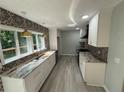 Modern kitchen with granite countertops, stainless steel appliances and beautiful backsplash at 5345 Pilgrim Point Rd, Cumming, GA 30041
