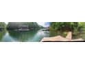 Lake view of boat docks on the water and trees in the background at 5345 Pilgrim Point Rd, Cumming, GA 30041