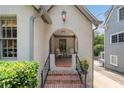 Inviting front porch with brick steps, rocking chairs, and elegant architectural details at 1748 N Pelham Ne Rd, Atlanta, GA 30324