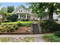 Charming two-story home with stone stairs, landscaped yard, and inviting front porch at 1276 Lanier Ne Blvd, Atlanta, GA 30306