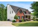 Two-story brick home featuring attached garage, and verdant lawn at 140 Melrose Creek Dr, Stockbridge, GA 30281