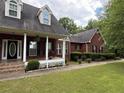 Lovely red brick home featuring a welcoming porch and lush green lawn at 349 Bald Rock Rd, Oxford, GA 30054