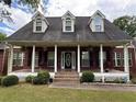 Charming home with a large, inviting front porch, perfect for relaxing and enjoying the outdoors at 349 Bald Rock Rd, Oxford, GA 30054