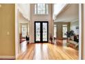 Grand foyer featuring hardwood floors and stylish decorative wrought iron double doors at 1595 Chadberry Way, Lawrenceville, GA 30043