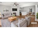 Bright, open living room with fireplace, modern decor, and access to dining area at 3968 Oak Glenn Dr, Duluth, GA 30096