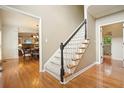 Traditional foyer with hardwood floors, staircase with carpet runner, and views into adjacent living spaces at 1206 Mountainside Nw Trce, Kennesaw, GA 30152