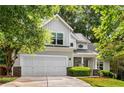 Charming two-story home featuring a well-manicured lawn, covered porch, and attached two-car garage at 1607 Boulder Walk Se Dr, Atlanta, GA 30316