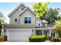 Charming two-story home featuring a well-manicured lawn, covered porch, and attached two-car garage at 1607 Boulder Walk Se Dr, Atlanta, GA 30316