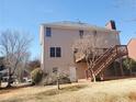 View of the back exterior with siding and a wooden deck at 4217 Mill Grove Sw Ln, Smyrna, GA 30082