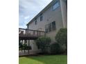 Back view of the home featuring a wooden deck, lower patio, and spacious yard at 4217 Mill Grove Sw Ln, Smyrna, GA 30082