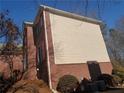A partial view of the side exterior with brick and siding at 4217 Mill Grove Sw Ln, Smyrna, GA 30082
