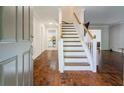 Inviting entryway with hardwood floors and a staircase leading to the upper level at 8895 Club River Dr, Roswell, GA 30076