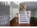 Inviting foyer showcasing hardwood floors and a staircase leading upstairs at 8895 Club River Dr, Roswell, GA 30076