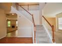 Inviting foyer with staircase, wood floors, and neutral paint at 136 Parkstone Way, Marietta, GA 30066