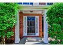 Covered front entrance featuring a black door flanked by sidelights at 136 Parkstone Way, Marietta, GA 30066