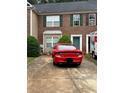 Brick townhome with driveway, green door, and a U-Haul moving truck nearby at 4612 Grand Central Pkwy, Decatur, GA 30035