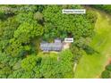 Aerial view of the home nestled among lush green trees in Covington, GA with shipping container shown at 740 Skyline Dr, Covington, GA 30014