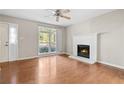 Living room featuring hardwood floors, a fireplace, and a large window at 1333 Laura Ln, Austell, GA 30168