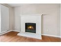 Living room featuring hardwood floors, a fireplace, and neutral paint at 1333 Laura Ln, Austell, GA 30168