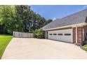 Wide driveway and attached three car garage with ample parking space at 3845 Glen Ian Dr, Loganville, GA 30052