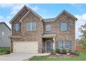 Two-story home with brick and stone accents, a two-car garage, and blue shutters at 1173 Gaines St, Jonesboro, GA 30238