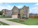 A two-story brick home with an attached garage is complemented by a green lawn and sidewalk at 1173 Gaines St, Jonesboro, GA 30238