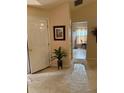 Inviting entryway with neutral tones, featuring a decorative plant and framed artwork at 2863 Hillvale Cove Dr, Lithonia, GA 30058