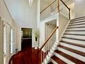 Inviting foyer with hardwood floors, staircase, and view into adjacent rooms at 415 Wood Trace Ct, Alpharetta, GA 30022
