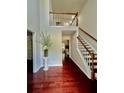 Grand foyer with hardwood floors, stairs and a second floor balcony overlooking the entry at 415 Wood Trace Ct, Alpharetta, GA 30022