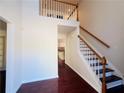 Bright foyer with hardwood floors, staircase, and open view of the home's interior at 415 Wood Trace Ct, Alpharetta, GA 30022