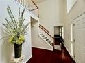 Bright foyer features hardwood floors, stairs, and a view into another room at 415 Wood Trace Ct, Alpharetta, GA 30022