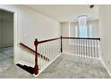 Upstairs landing features a decorative chandelier and carpet at 415 Wood Trace Ct, Alpharetta, GA 30022