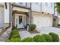 Inviting front porch with seating, a wreath on the front door, and charming curb appeal at 1241 Hightower Nw Xing, Marietta, GA 30060