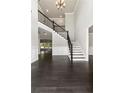 Spacious foyer with high ceilings, chandelier, staircase, and beautiful dark hardwood floors at 3415 Kenyon Creek Nw Dr, Kennesaw, GA 30152