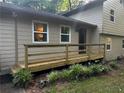 Inviting front porch with wooden railings, leading to the main entrance of the home and manicured landscaping at 3474 Leaf Land Ct, Duluth, GA 30097