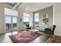 Spacious living room with balcony access, modern lighting, comfortable seating, and large windows providing natural light at 3820 Roswell Ne Rd # 510, Atlanta, GA 30342